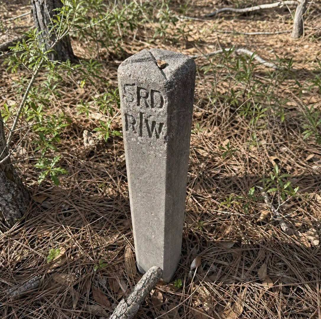 What Is This Concrete Marker Found in the Woods? image